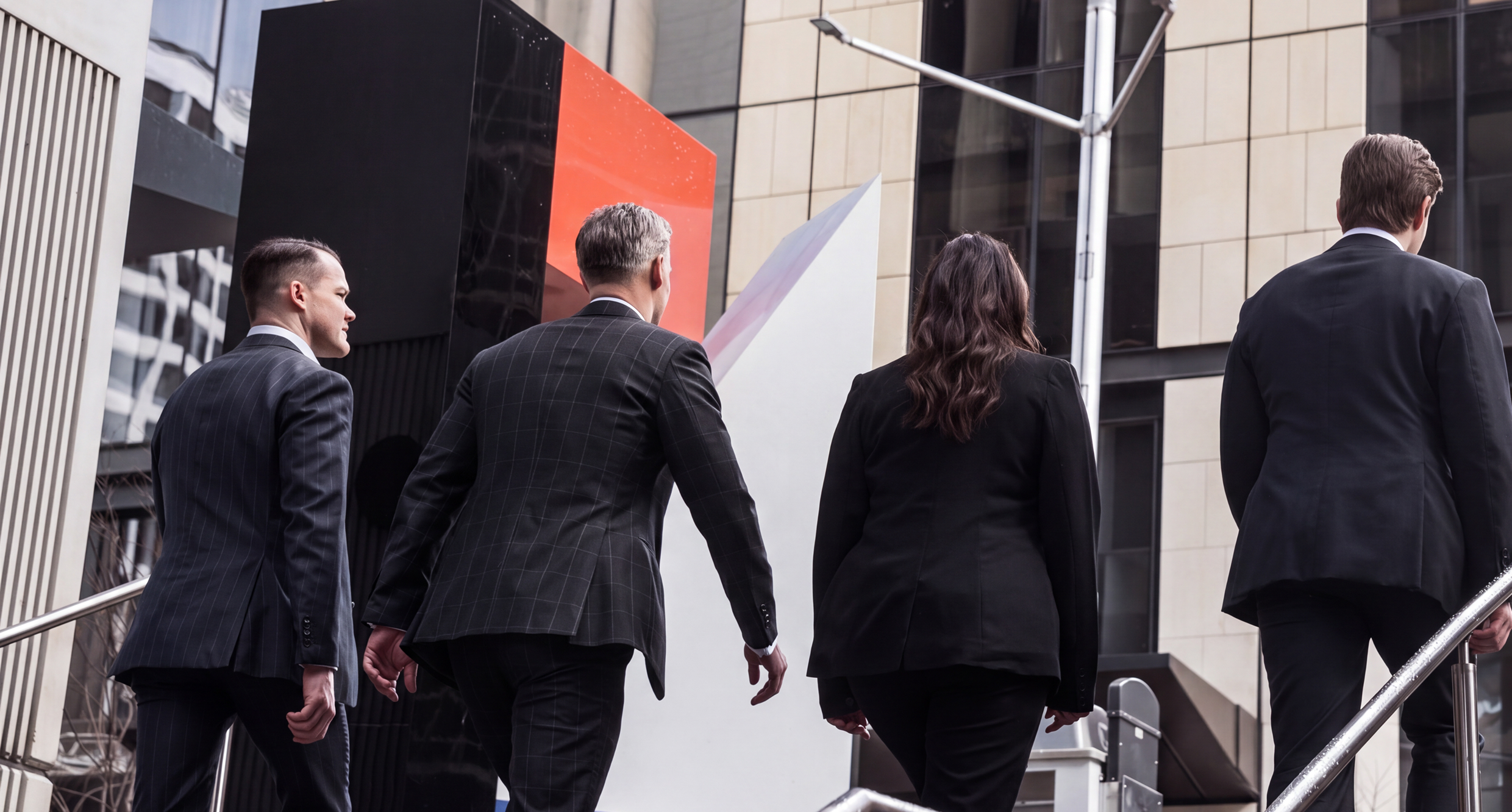 Business people walking up stairs in city